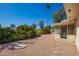 Private backyard boasts manicured landscaping, mature trees, and desert rock at 720 S Rosemont --, Mesa, AZ 85206
