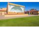 Sunland Village community with stage and mural for events; landscaped with green lawn and desert themed background art at 720 S Rosemont --, Mesa, AZ 85206