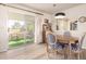 Charming dining area features a wood table with checkered chairs and access to a screened patio at 720 S Rosemont --, Mesa, AZ 85206
