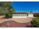 Exterior view shows the back of the home, mature trees and privacy wall at 720 S Rosemont --, Mesa, AZ 85206