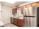 Well-lit kitchen features stainless steel appliances, wood cabinets and light countertops at 720 S Rosemont --, Mesa, AZ 85206