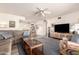 Open-concept living space featuring a sectional sofa, contemporary decor, and seamless flow to the dining area at 720 S Rosemont --, Mesa, AZ 85206