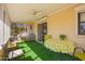 Enclosed lanai features a ceiling fan, bright yellow walls, and an artificial turf flooring at 720 S Rosemont --, Mesa, AZ 85206