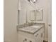 Bright bathroom featuring a granite countertop vanity with a large mirror and silver hardware at 7531 E Billings St # 131, Mesa, AZ 85207