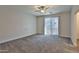 Bedroom with plush carpeting, a ceiling fan, and sliding glass doors to outdoor area at 7531 E Billings St # 131, Mesa, AZ 85207
