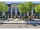 Charming townhome exteriors with wooden gates, lush trees, and sidewalks along the street at 7531 E Billings St # 131, Mesa, AZ 85207