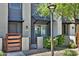 A close-up view of modern townhomes featuring private gated patios and landscaped surroundings at 7531 E Billings St # 131, Mesa, AZ 85207