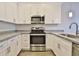 Stylish kitchen features stainless oven, granite counters, and white cabinets at 7531 E Billings St # 131, Mesa, AZ 85207