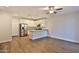 Open concept kitchen featuring stainless steel appliances, white cabinetry, and hardwood floors at 7531 E Billings St # 131, Mesa, AZ 85207
