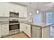 Stylish kitchen with granite counters, stainless appliances, and an island at 7531 E Billings St # 131, Mesa, AZ 85207