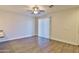 Bright living room features a ceiling fan, wood floors, and a large window at 7531 E Billings St # 131, Mesa, AZ 85207