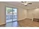 Bright living room with wood floors, a ceiling fan, and a sliding glass door leading to a patio at 7531 E Billings St # 131, Mesa, AZ 85207