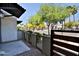 Cozy private patio with a fence and gate, offering a glimpse of the neighborhood street at 7531 E Billings St # 131, Mesa, AZ 85207