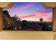 Exterior view of a balcony showing panoramic views of a tree-filled landscape at dusk with a gorgeous sunset at 7631 N 20Th St, Phoenix, AZ 85020