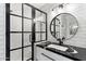 Modern bathroom with stylish black-framed shower glass and elegant vanity with marble countertop at 7631 N 20Th St, Phoenix, AZ 85020
