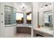 Bright primary bath featuring a corner tub with breathtaking exterior sunset views and modern finishes at 7631 N 20Th St, Phoenix, AZ 85020