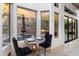 Cozy dining area with a view of the pool and outdoor seating through the large windows at 7631 N 20Th St, Phoenix, AZ 85020