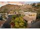 Exterior elevation of home with tiled roof, desert landscaping, palm trees, and a mountain in the background at 7631 N 20Th St, Phoenix, AZ 85020