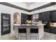 Modern kitchen with black cabinetry, white countertops, and seating at the island at 7631 N 20Th St, Phoenix, AZ 85020