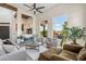 Well-lit living room with high ceilings, comfortable seating, and views of lush outdoor landscape at 7631 N 20Th St, Phoenix, AZ 85020