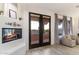 Bright living room showcasing a cozy fireplace, stylish french doors, and two comfortable chairs at 7631 N 20Th St, Phoenix, AZ 85020