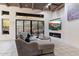 Modern living room with a fireplace, comfortable seating, and a sliding glass door to the patio at 7631 N 20Th St, Phoenix, AZ 85020