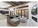 Open living room featuring wood beams, comfortable seating, fireplace, and views of the outdoor patio at 7631 N 20Th St, Phoenix, AZ 85020