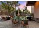 Outdoor patio featuring a dining set, grill, and comfortable seating area for relaxing, all set on a paver patio and manicured lawn at 7631 N 20Th St, Phoenix, AZ 85020