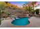 Stunning backyard with a sparkling pool and soothing waterfall feature, set against a scenic hillside backdrop at 7631 N 20Th St, Phoenix, AZ 85020
