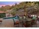 Beautiful backyard with a pool, waterfall, lounge chairs, and string lights for evening ambiance, perfect for relaxation at 7631 N 20Th St, Phoenix, AZ 85020