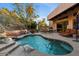 Inviting backyard pool with stone accents, lush landscaping, and outdoor seating at 7631 N 20Th St, Phoenix, AZ 85020