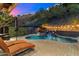 Stunning backyard with a sparkling pool, soothing waterfall, and comfortable lounge chairs, perfect for relaxation at 7631 N 20Th St, Phoenix, AZ 85020
