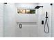 Sleek and modern shower with glass door, rainfall shower head, and convenient niche at 7631 N 20Th St, Phoenix, AZ 85020