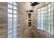 Modern tiled shower featuring glass block windows and sleek black fixtures at 7631 N 20Th St, Phoenix, AZ 85020