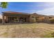 The cozy backyard features a covered patio, xeriscaping, and low walls at 870 E Tonto Pl, Chandler, AZ 85249