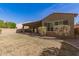 A spacious backyard with a covered patio, lush landscaping and a low-maintenance lawn at 870 E Tonto Pl, Chandler, AZ 85249
