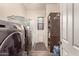Bright laundry room with modern machines and storage solutions at 870 E Tonto Pl, Chandler, AZ 85249