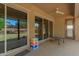 The covered patio has dual glass doors, a ceiling fan, and neutral tones at 870 E Tonto Pl, Chandler, AZ 85249