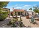 Backyard with a water fountain, tiled patio, pergola, and desert landscaping at 8719 E San Marino Dr, Scottsdale, AZ 85258