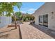 Relaxing backyard with brick pavers, water fountain, mature landscaping, and covered patio area at 8719 E San Marino Dr, Scottsdale, AZ 85258