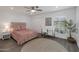 Cozy bedroom with a decorative round window, desk, and neutral tones at 8719 E San Marino Dr, Scottsdale, AZ 85258