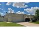 Charming single-story home featuring a two-car garage, arched entryway, and lush green lawn at 8719 E San Marino Dr, Scottsdale, AZ 85258
