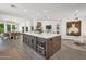 Open kitchen layout with a large center island, stainless steel appliances, and dining area access at 8719 E San Marino Dr, Scottsdale, AZ 85258