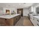 Well-lit kitchen with a spacious island, wine rack, stainless appliances, and open concept design at 8719 E San Marino Dr, Scottsdale, AZ 85258