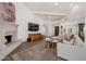 Comfortable living space with stylish fireplace, modern TV, and cohesive design elements for relaxation at 8719 E San Marino Dr, Scottsdale, AZ 85258