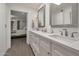 Bright bathroom featuring a double vanity with white countertop and framed mirrors at 8719 E San Marino Dr, Scottsdale, AZ 85258