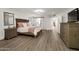 Spacious main bedroom with wood-look floors, barn door to main bathroom, and ample natural light at 8719 E San Marino Dr, Scottsdale, AZ 85258