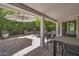 Private outdoor covered patio, perfect for entertaining, with beautiful landscaping and brick pavers at 8719 E San Marino Dr, Scottsdale, AZ 85258