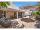 Wonderful outdoor living area featuring brick pavers, covered patio, a pergola, and mature landscaping at 8719 E San Marino Dr, Scottsdale, AZ 85258
