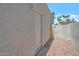 Exterior view of the side yard featuring stucco wall, alley access gate and brick pavers at 8719 E San Marino Dr, Scottsdale, AZ 85258
